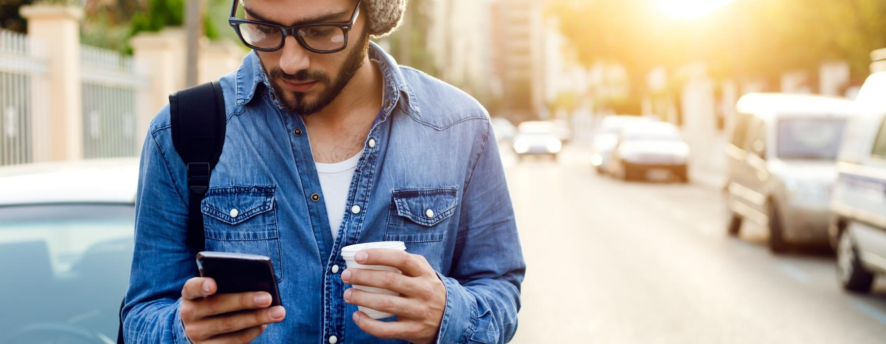 a man in a hat looking at his phone