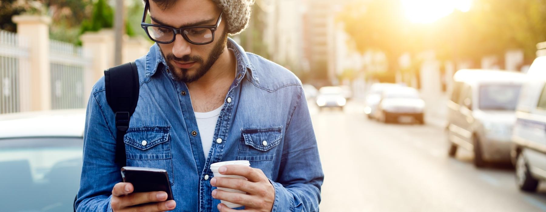 a man in a hat looking at his phone