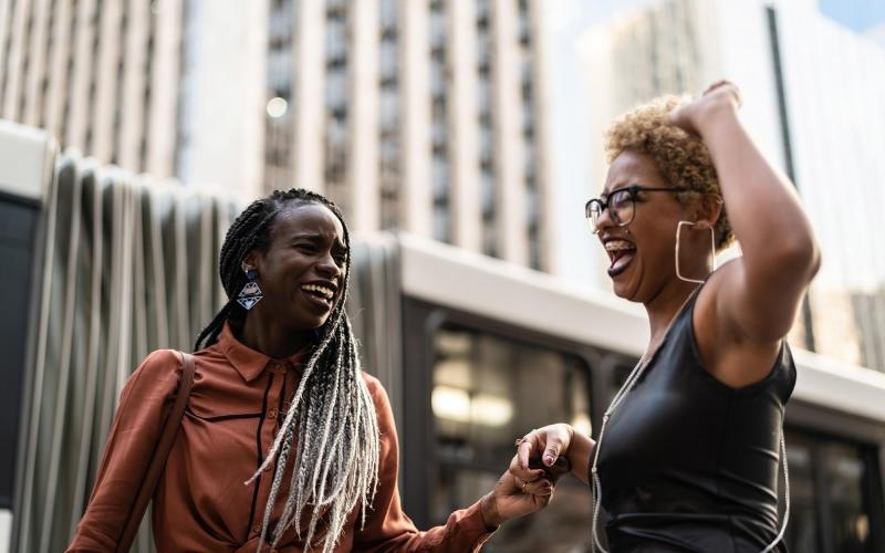 A beautiful community at the heart of all your passions women laughing together in the city