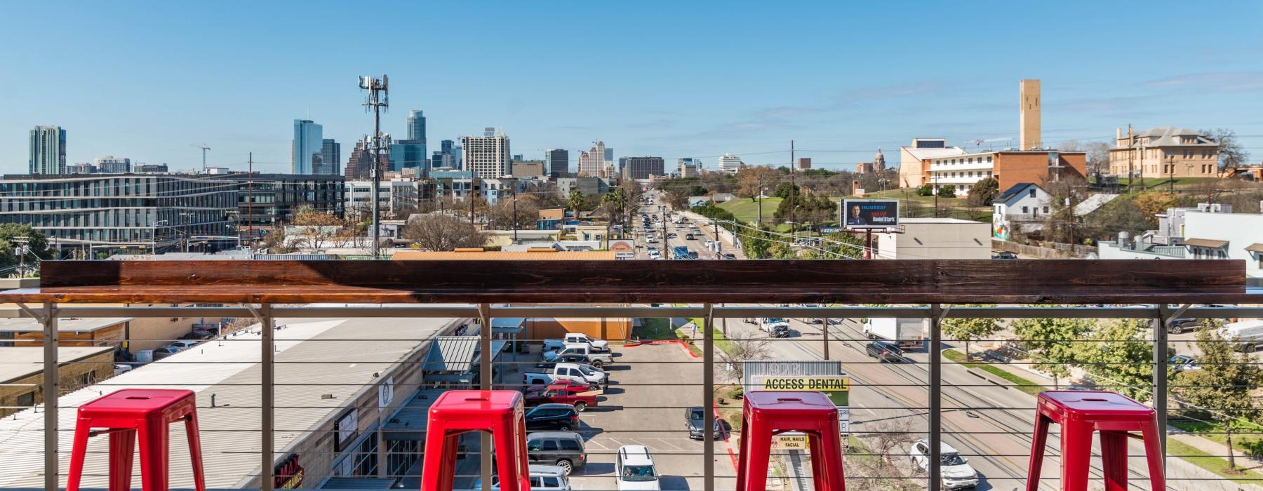 a parking lot with cars and buildings in the background