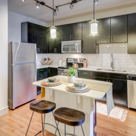 Spacious kitchens with thoughtful details a kitchen with a table and stools