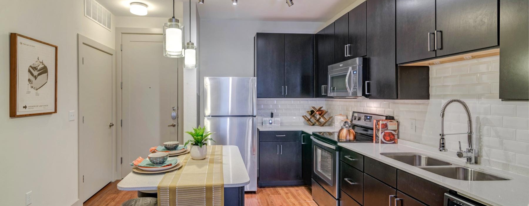 a kitchen with a table and chairs