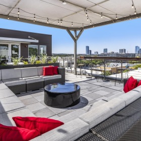 Find your perfect fit at 7East a room with a couch and a table with a view of a city