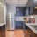 a kitchen with a stainless steel refrigerator