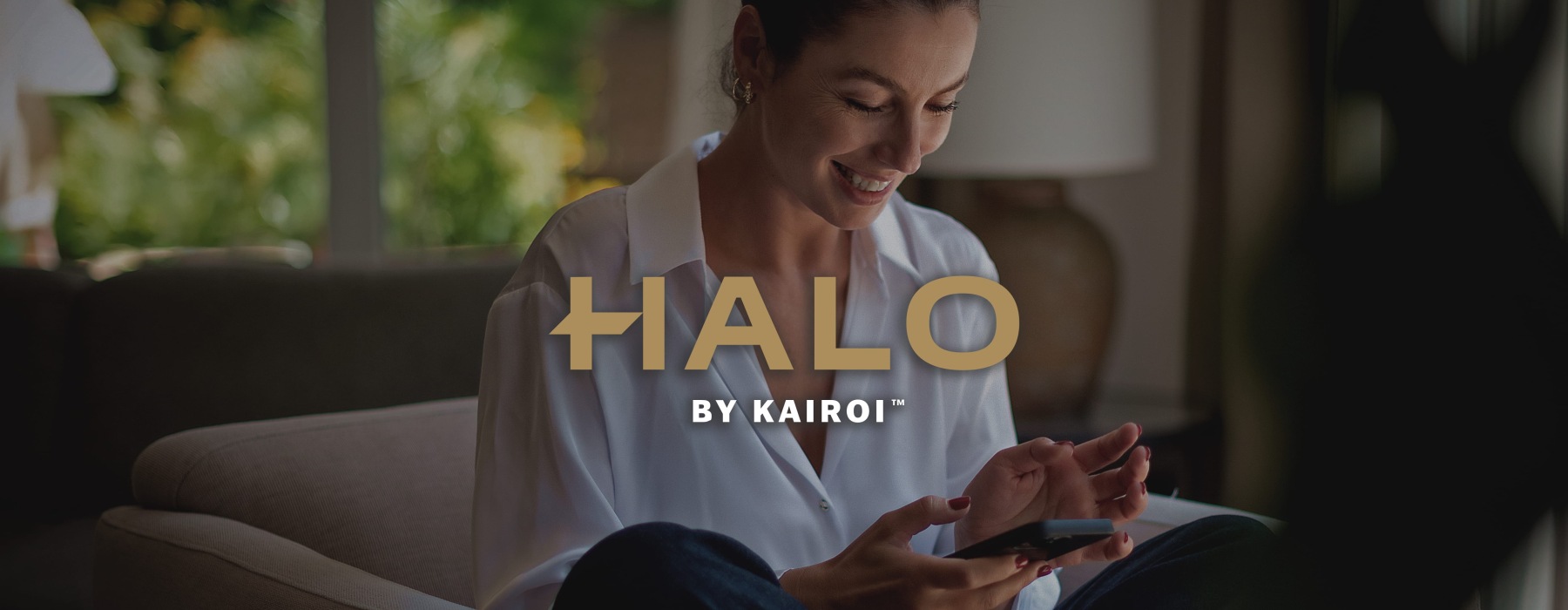 a woman smiling and interacting with her device